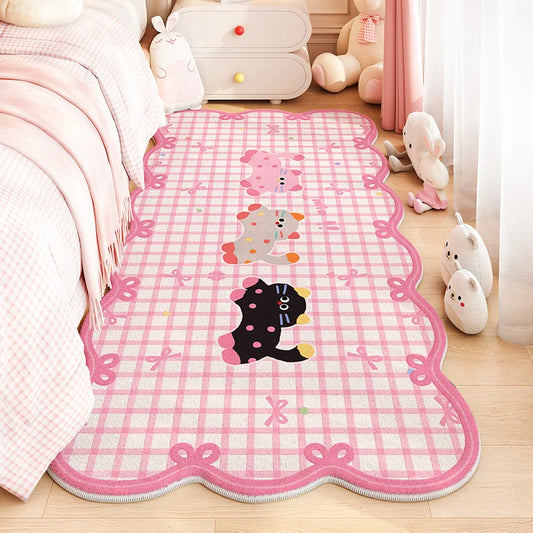 A pink and white checkered rug with cartoon animal prints and bow borders, styled on a wooden floor in a soft pink children's bedroom next to a bed and plush toys.