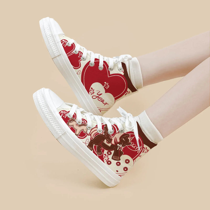 A pair of high-top canvas sneakers with a red and white Valentine's Day theme shown on a model's feet against a solid beige background.