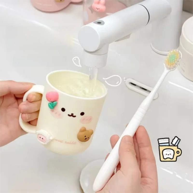 Person holding a kawaii mug with a face, pouring water into it, and a toothbrush next to it on a white background.
