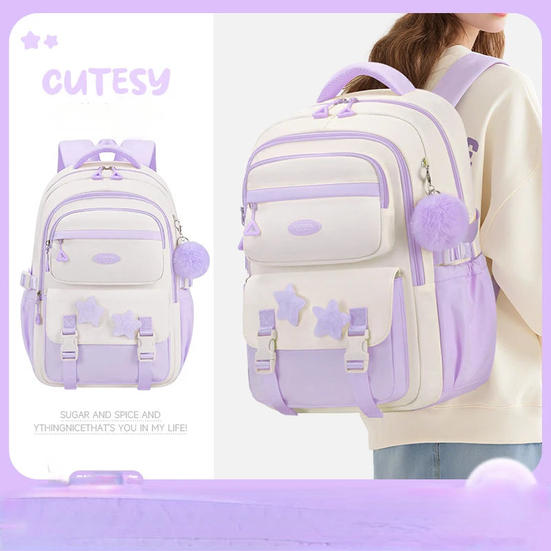 White and purple backpack with star designs, worn by a person, on a light purple background.