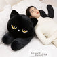 Woman resting on a black Kawaii sleepy cat body pillow  plushie