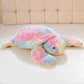 Plush  pastel turtle being displayed against a white background