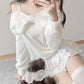 Kawaii White Sweet Off Shoulder Sweater worn by a woman sitting down with a teddy bear
