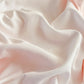 Close-up of soft pink fabric with folds