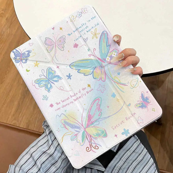 Hand holding the ipad case with colorful butterfly designs on a wooden background