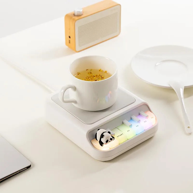 White Kawaii Panda Piano Cup Heater on a table 