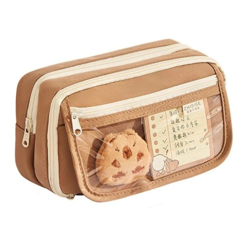 Brown rectangular pouch with a clear compartment containing a small plush toy and a card on a white background