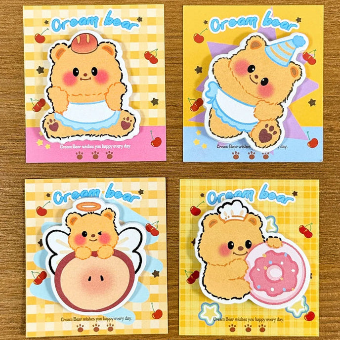 This image is displaying the 4pcs Creamy Bear Sticky Notes 4 different designs that come in the pack, this is shown on a wooden desk. 