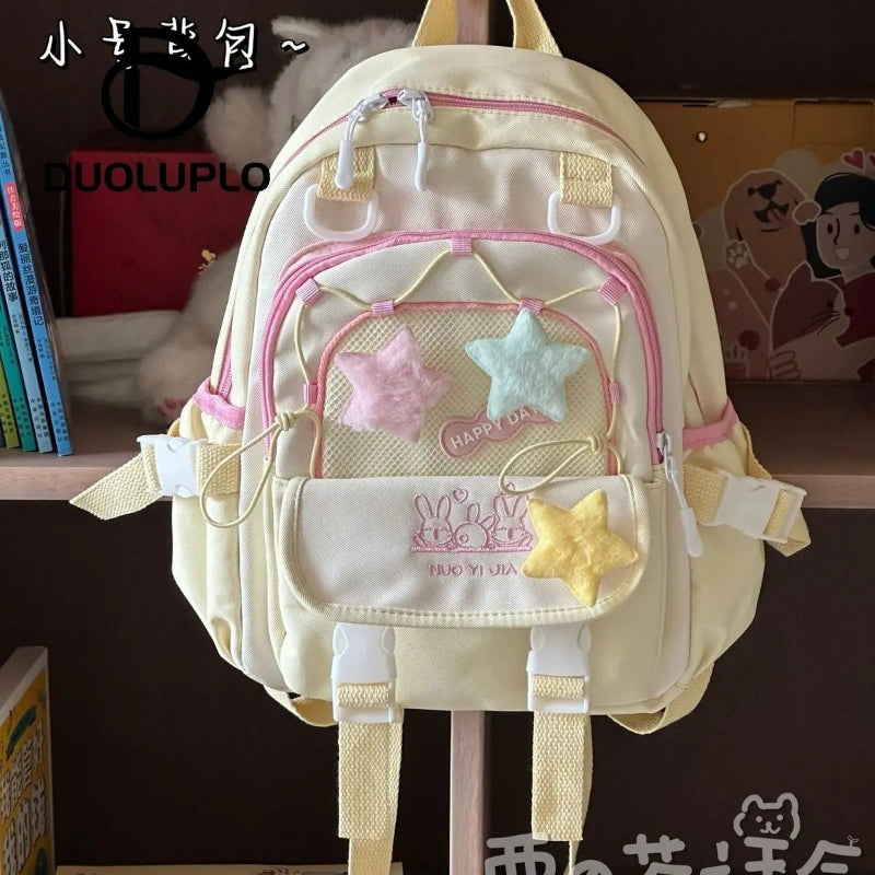 Kawaii backpack with star designs on against a shelf