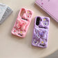 This image is showing two designs that are available for the Kawaii Butterfly Samsung Phone Case, one option is the pink design with a large 3D butterfly in the middle which is a phone grip with smaller butterflies around it and some white flowers, the other option is of this the same design but in purple.
