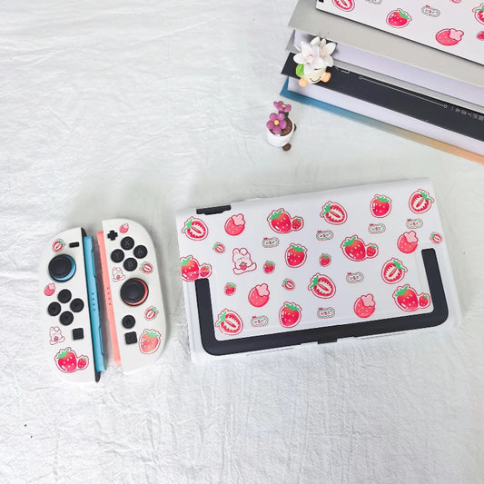 Nintendo switch 2 console with strawberry-themed stickers on a white surface