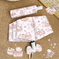 Cute cartoon-themed umbrella with a matching pouch on a textured surface.
