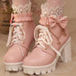 Pink boots with lace details and a bow on a beige background