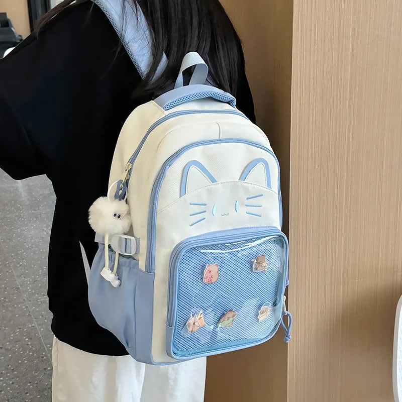 Blue neko backpack displayed by person holding them.
