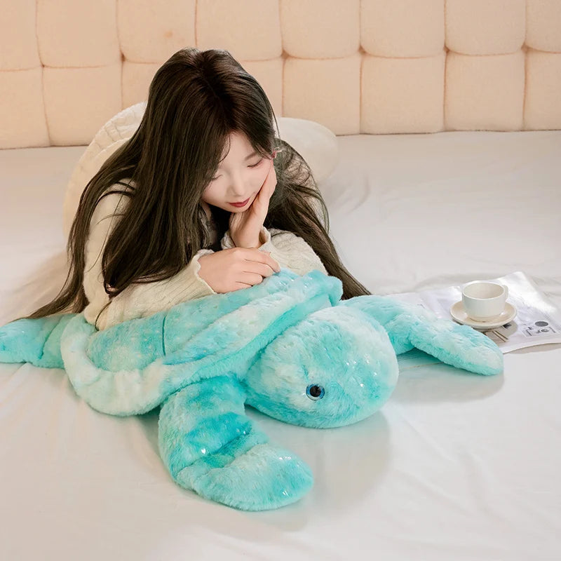 Plush blue turtle being laid on