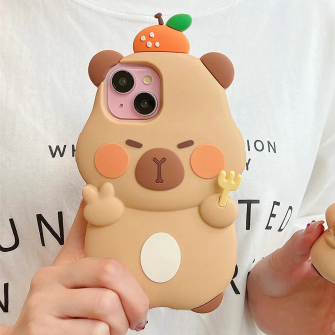 Person holding a cute capybara phone case with a white shirt in the background