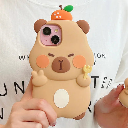 Person holding a cute capybara phone case with a white shirt in the background