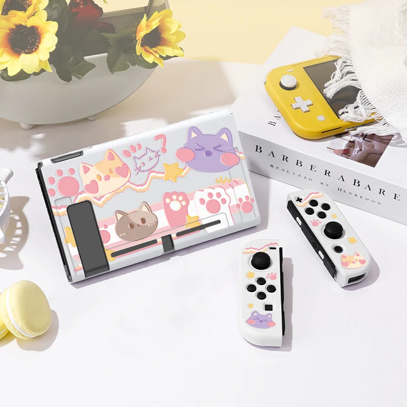 Gaming console with cartoon cat designs on a white surface with a floral arrangement in the background.