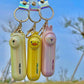 Three mini fans with animal designs and 'mini fan' text on a blurred natural background