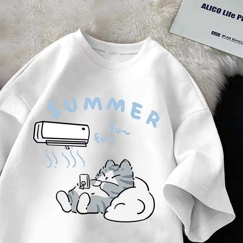 White t shirt with a cartoon design of a cat relaxing under an air conditioner, labeled 'Summer', on a textured surface.