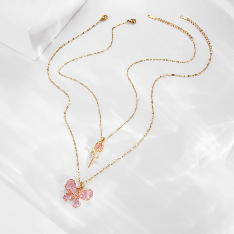 Kawaii Enchanting Butterfly Rose Necklace on a marble countertop in the pink color 