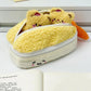 Kawaii yellow tempura shrimp plush pencil case with bears on a white surface. 