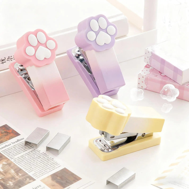Kawaii Pastel Cat Paw Stapler, this image is showing the different colors you can get of the cat paw stapler which include pink, purple and yellow.
