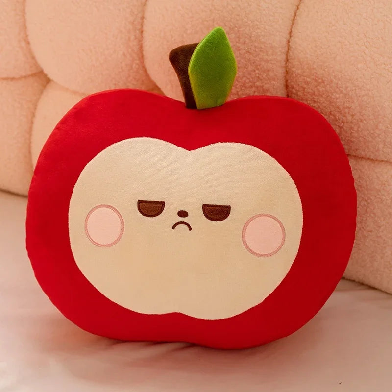 Plush toy shaped like a red apple with a unimpressed face on a soft pink background