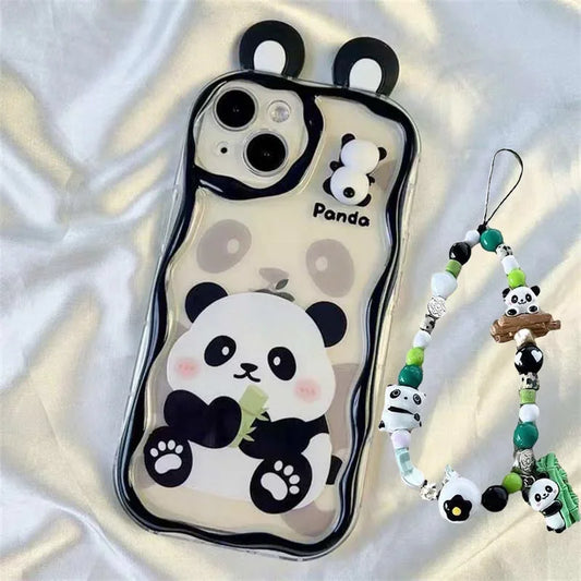 kawaii panda samsung phone case with beaded charm attached and ears on a white silk background, panda on the phone case is sat eating bamboo