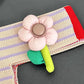 Fabric flower toy on a striped fabric background
