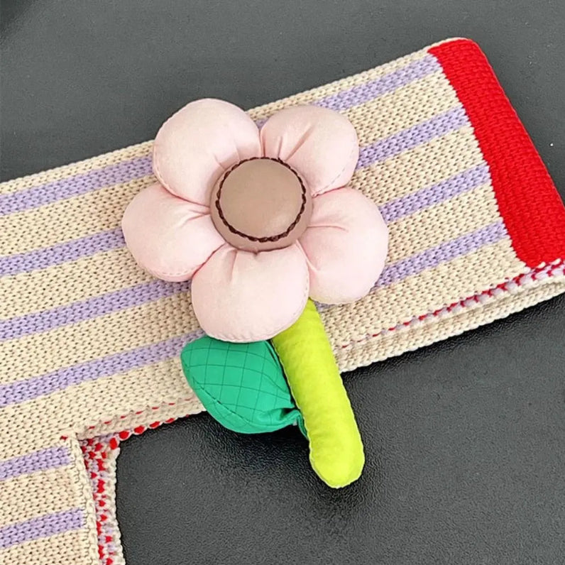 Fabric flower toy on a striped fabric background