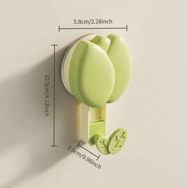 Green wall hook with measurements on a beige background