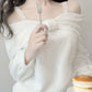 Kawaii White Sweet Off Shoulder Sweater worn by a woman eating pancakes 