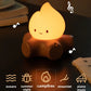 Camping-themed night light with white noise and ambient lighting options on a wooden surface.