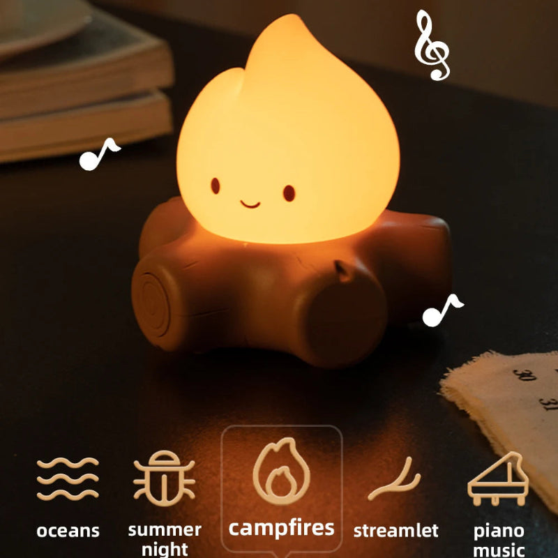 Camping-themed night light with white noise and ambient lighting options on a wooden surface.