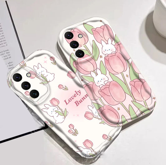 Phone case with pink tulips and bunnies on a white surface