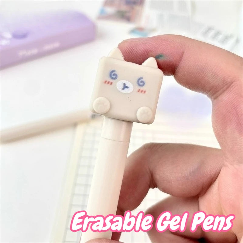 Kawaii Cat Erasable Gel Pens, this is showing a close up of the cream designed one and the expression on its face while on a desk background along side notes