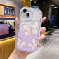 Phone case with butterfly design held in a hand, blurred cafe background