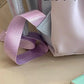 beary cute ita  backpack with pink straps on a beige surface.