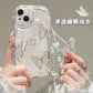 Clear phone case with butterfly design held by a hand, featuring a decorative chain.