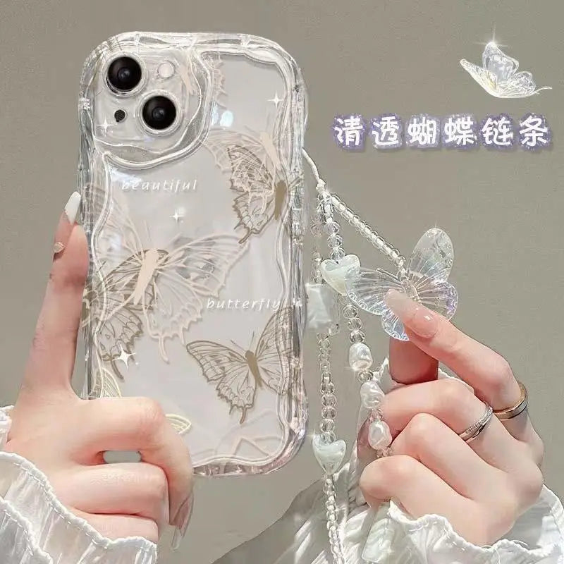 Clear phone case with butterfly design held by a hand, featuring a decorative chain.
