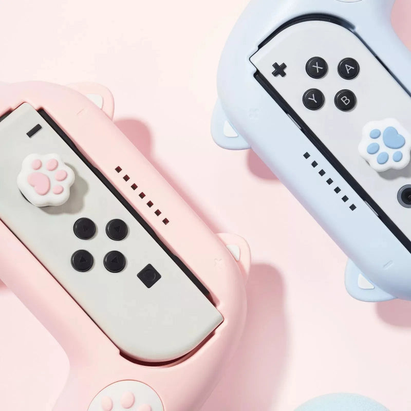 Two gaming controllers with paw-shaped buttons on a pink background