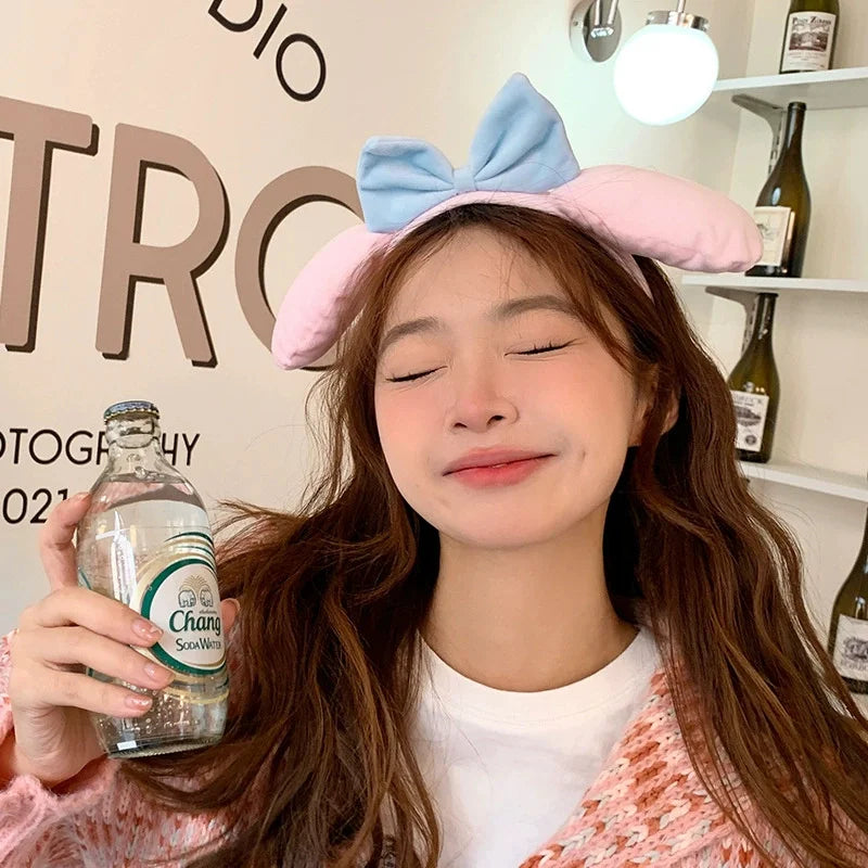 Woman modeling the Kawaii Bunny Ears Headbands , this design is the pink and blue edition.