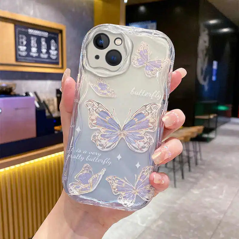 Phone case with butterfly design held by a person in a cafe setting