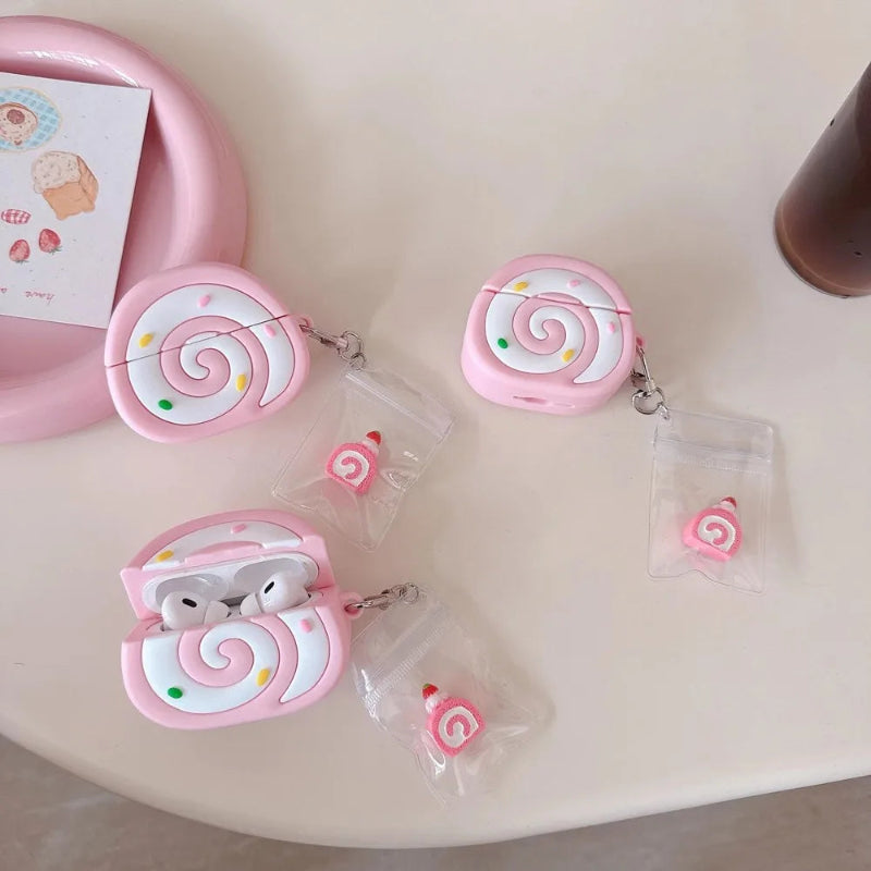Pink swiss roll shaped air pod case on a white table.