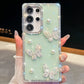 Phone case with butterfly and pearl designs held by a hand, mint green color