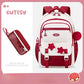 Red and white backpack with star designs on a pink background, featuring the brand 'Cutesy'.
