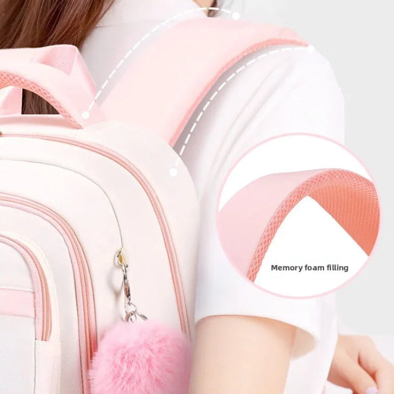 Backpack with pink shoulder strap and memory foam padding, featuring text on comfort upgrade.