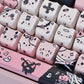 This image is showing a close up of the Kawaii Creepy Cuties Keyboard Keycaps, showing the designs on the keycaps such as cute cat faces  with skull necklace around their ear or bandages round their tiny tummies.