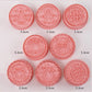 Set of pink Christmas-themed cookie stamps on a white background